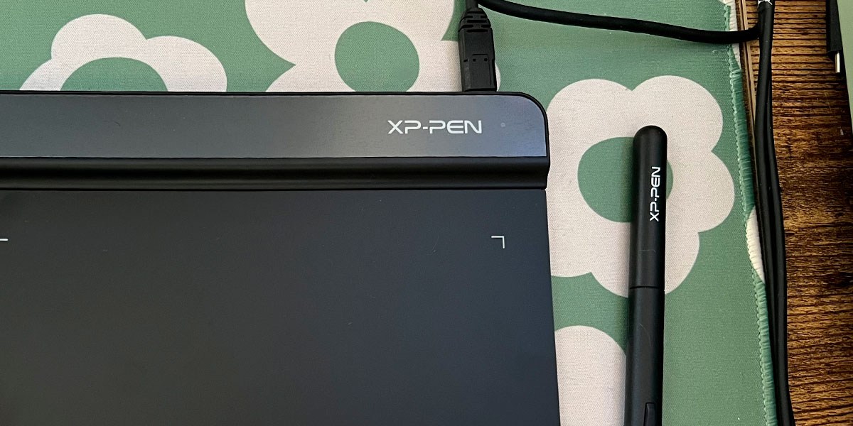 XP-Pen Star G640 and stylus pen on green and white background XP-Pen Star G640 and stylus pen on green and white background