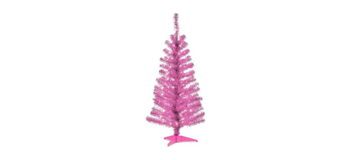 a pink artificial Christmas tree that is prelit and comes with a pink stand a pink artificial Christmas tree that is prelit and comes with a pink stand