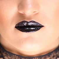 a woman with black lipstick