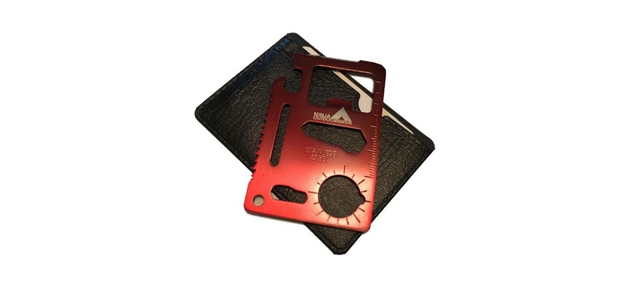 Best Ninja Outdoorsman 11-in-1 Stainless Steel Credit Card Tool sitting on black leather wallet