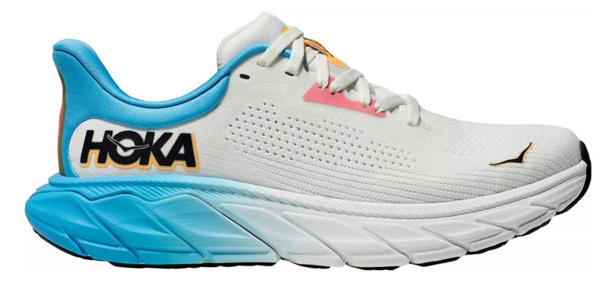 A white Hoka sneaker with a blue heel and coral and pink accents. 