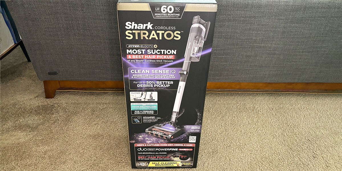 Shark Vertex Cordless product box on carpet next to sofa