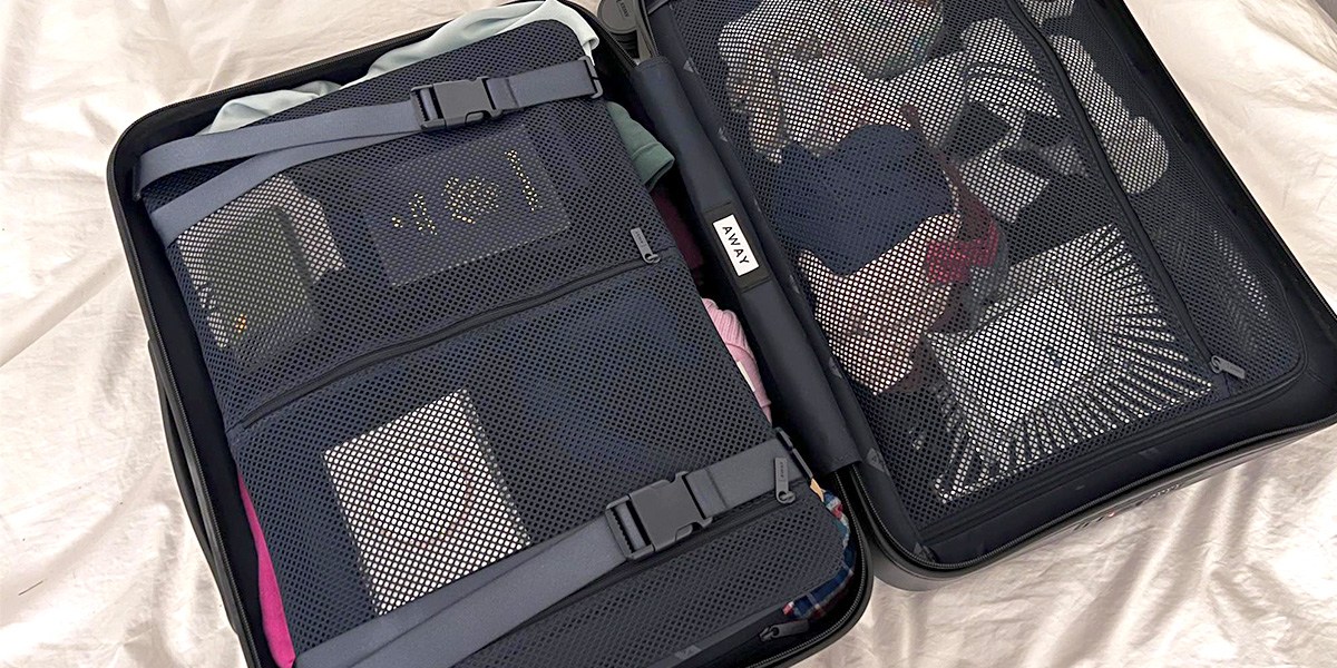 Away Carry-On fully open on bedding